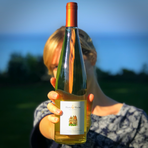 Jessica Bell standing behind a bottle of Gruner Veltliner, perfect for a HaloVino wine tumbler.