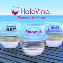 Three HaloVino wine tumblers with sayings for moms sitting on a deck by the ocean.