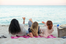 Three ladies on a beach with their reusable HaloVino wine tumblers.